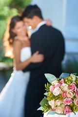 Image showing Flower bouquet, happy couple and blurred embrace at wedding with love, smile and commitment at reception. Roses, woman and man hugging at marriage celebration event, partnership and future together.