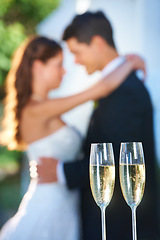 Image showing Champagne, happy couple and blurred embrace at wedding with love, smile and commitment at reception. Wine glasses, woman and man hugging at marriage celebration event, partnership and future together