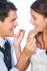 Image showing Wedding, cake and couple with smile, feeding and commitment celebration at luxury event together. Sharing dessert, eating and woman with man at marriage party with tradition, loyalty culture and love