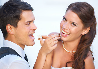 Image showing Portrait, wedding cake and couple with smile, feeding and commitment celebration at luxury event together. Sharing dessert, eating and woman with man at marriage with tradition, loyalty and love.