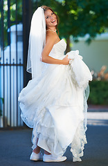 Image showing Outdoor portrait of bride, smile and dress and celebration of love in garden with sneakers. Wedding fashion, marriage event and excited happy woman in driveway with tradition and culture of romance.