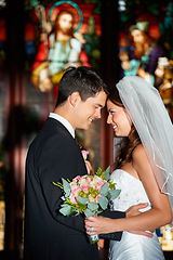 Image showing Happy couple, wedding and love at church for marriage, affection or commitment together at ceremony. Married man and woman touching foreheads with bouquet of roses or flowers in romantic relationship