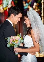 Image showing Happy couple, wedding and love at church for commitment, marriage or affection together at ceremony. Married man and woman smile in joy with bouquet of roses or flowers for romantic relationship