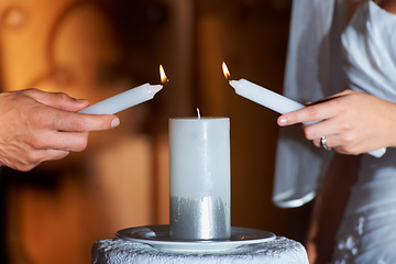 Image showing Couple, hands and candle at wedding for love, unity and commitment at church or ceremony with closeup. Marriage, man and woman with light for trust, relationship and compromise with bride and groom
