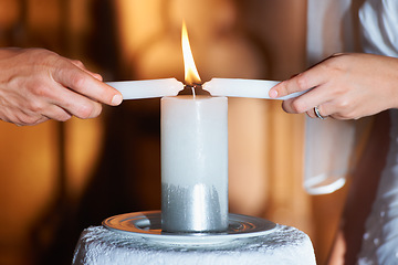 Image showing Couple, hands and candle at wedding for unity, love and commitment at church or ceremony with closeup. Marriage, man and woman with light for trust, relationship and faith with bride and groom