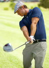 Image showing Sports, swing and man playing golf on green grass, course or field with club for game, practice and training for competition. Professional golfer, athlete or person hitting ball for stroke or score