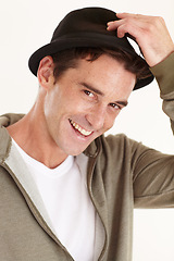Image showing Fashion, happy and portrait of man in studio with hat for trendy clothes, accessory and style. Smile, closeup and face of isolated person with confidence, pride and happiness on white background