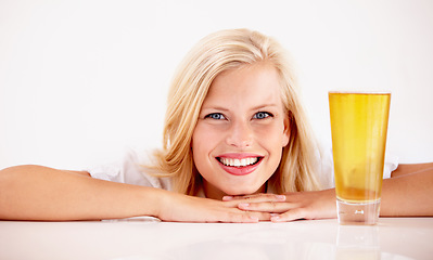 Image showing Woman, portrait and smile with beer drink in studio for weekend relax, summer beverage on white background. Female person, face and model or alcohol glass as pint enjoyment, cider ale or mockup space