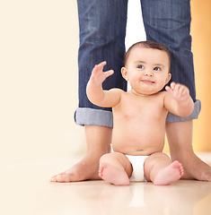 Image showing Baby, mother and feet with sitting on floor for playing, child development and parenting with happiness. Kid, infant and diaper on ground with legs, smile and playful for growth, nurture and care