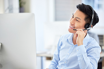 Image showing Man, headset and phone call at telemarketing office or smile for customer care, service or sale discussion. Asian person, computer and communication or support conversation, online sales at help desk