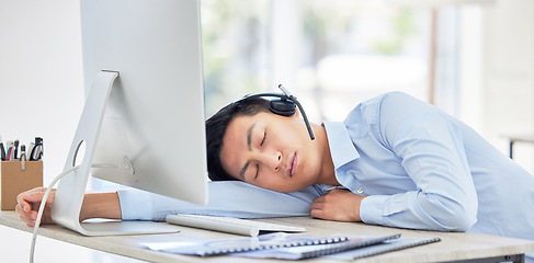 Image showing Call center, businessman and sleeping on desk and tired while being overworked and exhausted. Nap, rest and contact us overtime with a male person or agent sleep in customer service job