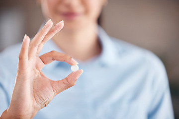 Image showing Hand, medicine or pill with a woman closeup for healthcare advice for medical treatment and cure. Tablet, wellness and pharmaceutical drug for vitamin or mineral supplement in the fingers of a person