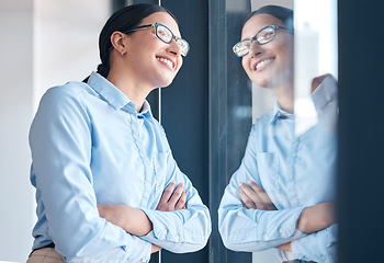 Image showing Business, woman and thinking at window with arms crossed, confidence and vision in office. Entrepreneur, dream and inspiration for ideas, planning and goals in workplace and startup in Portugal