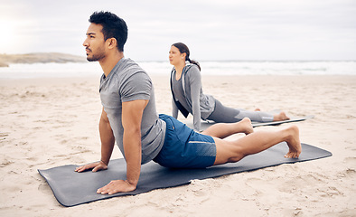 Image showing Exercise, yoga and wellness with a couple on the beach for a mental health or awareness workout in the morning. Fitness, pilates or mindfulness with a young man and woman by the ocean or sea for zen