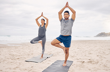 Image showing People, yoga and tree pose on beach for fitness, exercise and holistic wellness and teamwork outdoor. Couple of friends or instructor with balance, pilates and health or calm workout by ocean or sea