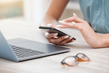 Image showing Hands, phone and a business woman at a desk in her office for communication, networking or search. Laptop, planning and glasses with an employee typing a text message closeup in the workplace