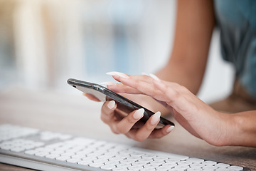 Image showing Hands, phone and keyboard with a business woman at a desk in her office for communication or networking. Computer, planning and search with an employee typing a text message closeup in the workplace