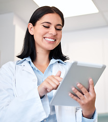 Image showing Smile, tablet and young woman doctor with confidence in her office doing research at clinic. Happy, medical and professional female healthcare worker from Canada with digital technology in hospital.