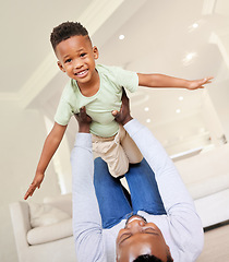 Image showing Airplane, smile and portrait of child with father in the living room of modern house having fun. Happy, love and young African boy kid playing with his dad on the floor of the lounge at home together