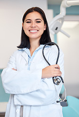 Image showing Stethoscope, crossed arms and portrait of woman dentist with confidence in her office at the clinic. Happy, medical and young female orthodontist or dental doctor with positive attitude in hospital.