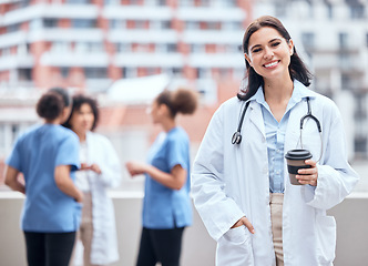 Image showing Woman, doctor and portrait of happy coffee break, outdoor and relax at hospital, clinic or colleagues on rooftop. Surgeon, smile and enjoy drink on balcony and working in healthcare and medicine