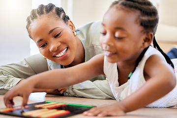 Image showing Education, smile and black woman playing with child on the floor in the living room at modern home. Abacus, mathematics and young African mother helping girl kid with counting at house together.