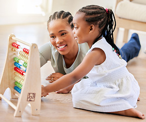 Image showing Education, happy and black woman playing with kid on the floor in the living room at modern home. Abacus, mathematics and young African mother helping girl child with counting at house together.