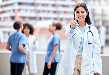 Image showing Thumbs up, portrait and doctor or woman in medical support, thank you or excellence for hospital services. Happy person or student outdoor with like, yes and okay hand or emoji for healthcare success