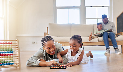 Image showing Education, happy and black woman playing with child on the floor in the living room at modern home. Abacus, mathematics and young African mother helping girl kid with counting at house together.