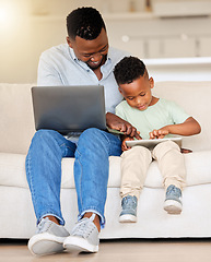 Image showing Family, man and boy with laptop for teaching in home for learning, playing and game on tablet. Father, kid and childcare with technology for skill, growth and development in milestone in living room