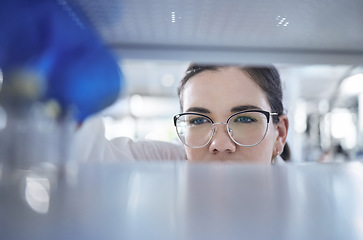 Image showing Science, search and the eyes of a woman in a laboratory for research, innovation or medical storage. Healthcare, medical and pharmaceuticals with a young scientist in a lab for cure development