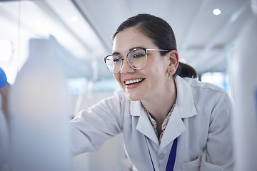 Image showing Woman, medical scientist and in lab happy for vial discovery or research future vaccine, review or technology. Female person, glasses and study breakthrough for antibiotic, help job or innovation