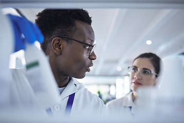 Image showing People, scientist or team checking inventory in lab for experiment, sample bottle or chemical. Young man and woman in teamwork together for science research, stock check or product test at laboratory