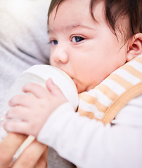 Image showing Face, milk and a baby drinking from a bottle closeup with a parent for health, diet or nutrition. Food, formula or calcium and an adult feeding a hungry infant child for growth and development