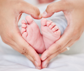 Image showing Mother, baby and feet with heart hands for love and care or security with rest or comfort and peace. A woman and infant child toes in shape of a mom for safety in family home for growth and insurance