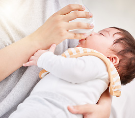 Image showing Mother, baby and feeding bottle with love and care or nursing with rest or nap in comfort and peace. A woman and girl child asleep in arms of a mom with formula milk in a family home for growth