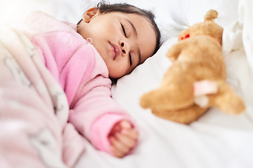 Image showing Baby, girl and sleeping in bed with teddy bear, animal and peace in home with blanket and comfort. Child, rest and sleep in morning, nap and routine for health, wellness and calm face of infant