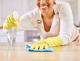 Image showing Happy woman, spray bottle and hands cleaning table in housekeeping, hygiene or disinfection in kitchen. Closeup of female person gloves wiping surface counter or furniture in bacteria or germ removal