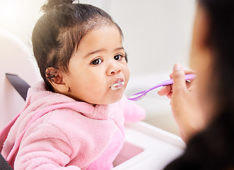 Image showing Hand, feed and child food in chair for baby development, nutrition meal or dinner snack. Kid, spoon and eating breakfast hungry for parent care or love for lunch together, messy morning in kitchen