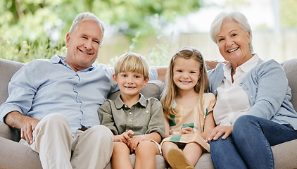 Image showing Smile, portrait and children with grandparents on a sofa in the living room of modern family home. Happy, love and young kids sitting with grandfather and grandmother on couch in the lounge at house.