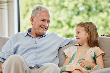 Image showing Conversation, smile and grandfather with child on a sofa bonding, relaxing and talking at home. Happy, family and senior man speaking to young girl kid on a couch in the living room at modern house.