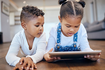 Image showing Children, youth and tablet for streaming in home on web, internet or app for entertainment. Siblings, little girl and boy with technology for learning, game and fun by lying, floor and living room