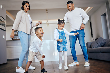 Image showing Dance, love and energy with a family having fun in the living room of their home together. Freedom, smile or happy with a mother, father and excited children moving or playing in their apartment