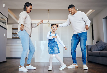 Image showing Dance, love and freedom with an interracial family having fun in the living room of their home together. Energy, smile or happy with a mother, father and excited daughter moving in their apartment