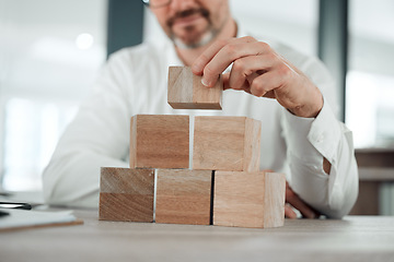 Image showing Building blocks, hands and business man in office for future planning, insurance or finance. Wood, puzzle and closeup of male entrepreneur with asset management, investment or financial security