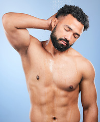 Image showing Shower, cleaning and man relax and calm from water, skincare and morning body routine. Bathroom, cosmetics and male model in a studio with blue background and dermatology for wellness and wash