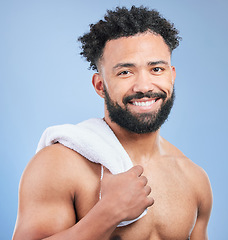 Image showing Shower towel, grooming portrait or happy man in morning routine, beauty cleaning or self care maintenance. Bathroom smile, happiness or studio person hygiene, bath or face skincare on blue background