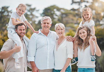 Image showing Portrait of big family in nature with piggy back, grandparents and parents with kids in backyard. Trees, happiness and men, women and children in garden with love, support and outdoor bonding in park