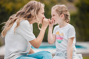 Image showing Family, secret or pinky promise with a mother and daughter outdoor in their garden or backyard together. Smile, love or happy with a young woman and her girl child at home to whisper for gossip