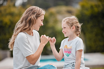 Image showing Outdoor, swear and mother with girl, pinky promise and relax with happiness, bonding or commitment link. Family, mama or kid with hand gesture, support or love in a park, secret or nature with trust